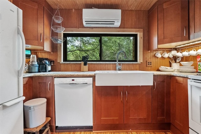 415 Balch Rd, Elgin, TX 78621 - kitchen with white appliances, a wall mounted air conditioner, light countertops, brown cabinets, and wood walls