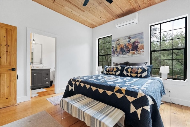 415 Balch Rd, Elgin, TX 78621 - bedroom with a wall mounted AC, light wood-type flooring, wooden ceiling, connected bathroom, and ceiling fan
