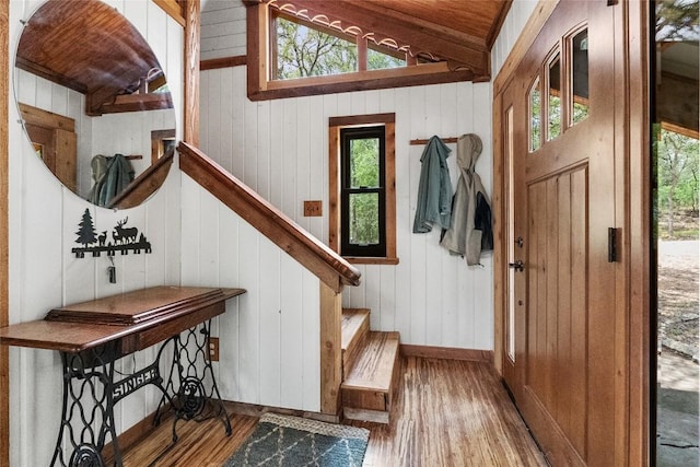 415 Balch Rd, Elgin, TX 78621 - entrance foyer with wood finished floors, vaulted ceiling, wood walls, and stairway