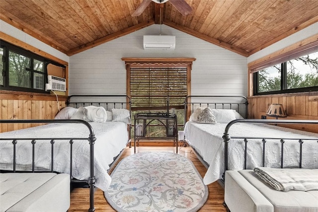 415 Balch Rd, Elgin, TX 78621 - bedroom with wooden ceiling, wood walls, wood finished floors, vaulted ceiling, and a wall unit AC