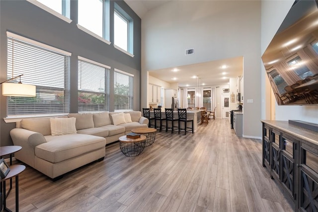 24822 Levante Dr, Richmond, TX 77406 - living area with light wood-style flooring and a towering ceiling