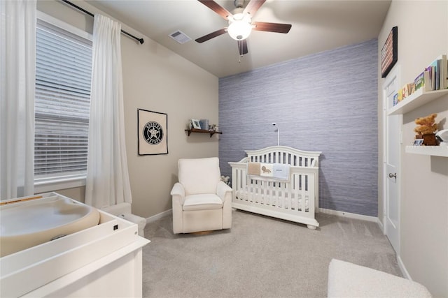 24822 Levante Dr, Richmond, TX 77406 - bedroom with wallpapered walls, carpet flooring, an accent wall, ceiling fan, and a nursery area