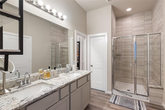 24822 Levante Dr, Richmond, TX 77406 - full bath with a shower stall, double vanity, wood finished floors, and recessed lighting