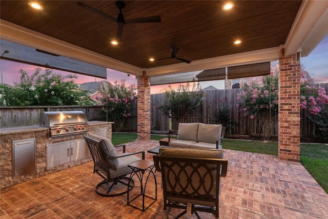 24822 Levante Dr, Richmond, TX 77406 - fenced backyard featuring an outdoor kitchen, a ceiling fan, outdoor lounge area, and a patio area