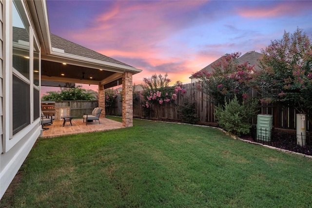 24822 Levante Dr, Richmond, TX 77406 - yard at dusk featuring a patio area and a fenced backyard