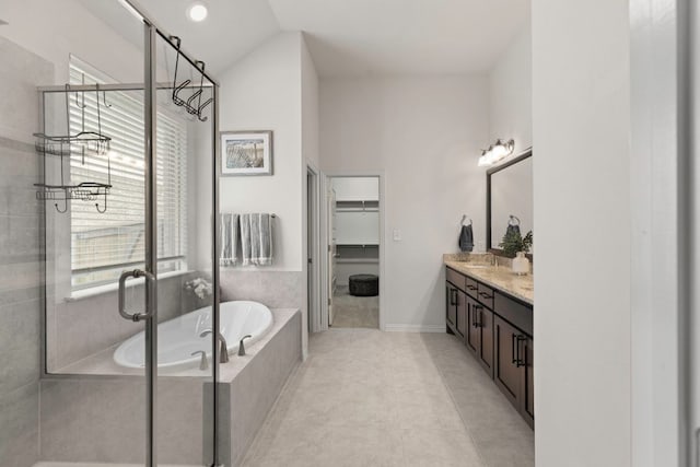232 Silver Pass, Kyle, TX 78640 - full bath featuring vanity, a bath, a stall shower, healthy amount of natural light, and vaulted ceiling