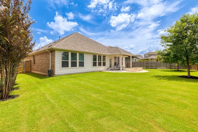 232 Silver Pass, Kyle, TX 78640 - rear view of house with a patio area, a fenced backyard, brick siding, and roof with shingles