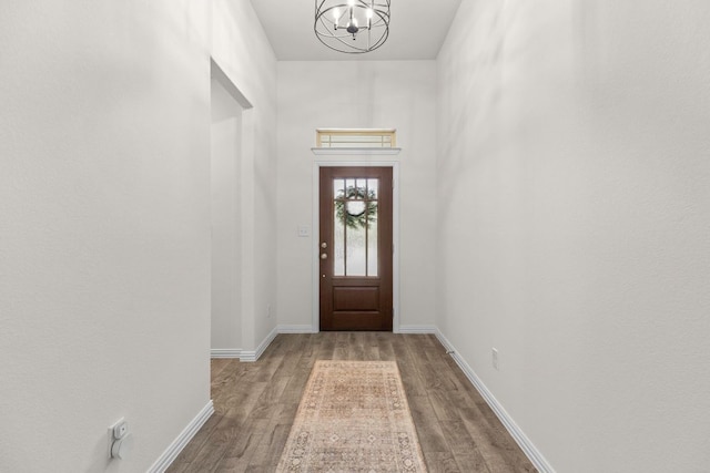 232 Silver Pass, Kyle, TX 78640 - doorway to outside featuring a chandelier and wood finished floors