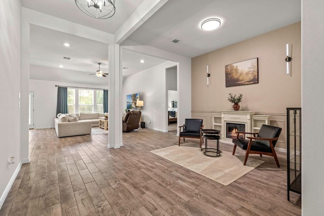 232 Silver Pass, Kyle, TX 78640 - living room with wood finished floors, a glass covered fireplace, recessed lighting, and ceiling fan