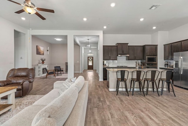 232 Silver Pass, Kyle, TX 78640 - living area with light wood finished floors, a ceiling fan, and recessed lighting