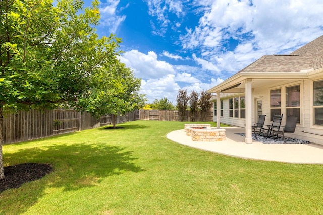 232 Silver Pass, Kyle, TX 78640 - fenced backyard featuring an outdoor fire pit and a patio area