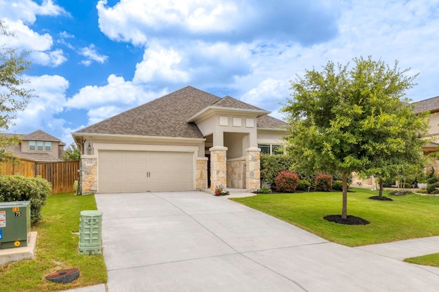 232 Silver Pass, Kyle, TX 78640 - prairie-style house featuring a garage, concrete driveway, stone siding, roof with shingles, and stucco siding