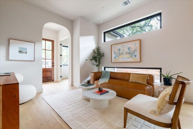 3003 W French Pl Unit 1, Austin, TX 78722 - living area featuring light wood finished floors and arched walkways