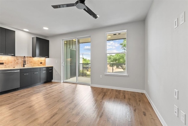 4510 Terry-O Ln Unit 205, Austin, TX 78745 - kitchen with dishwasher, dark cabinets, decorative backsplash, light wood-style flooring, and light countertops