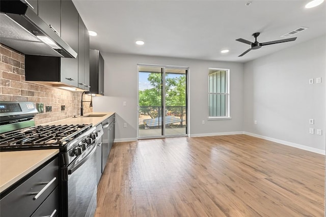 4510 Terry-O Ln Unit 205, Austin, TX 78745 - kitchen featuring stainless steel appliances, extractor fan, a ceiling fan, tasteful backsplash, and recessed lighting