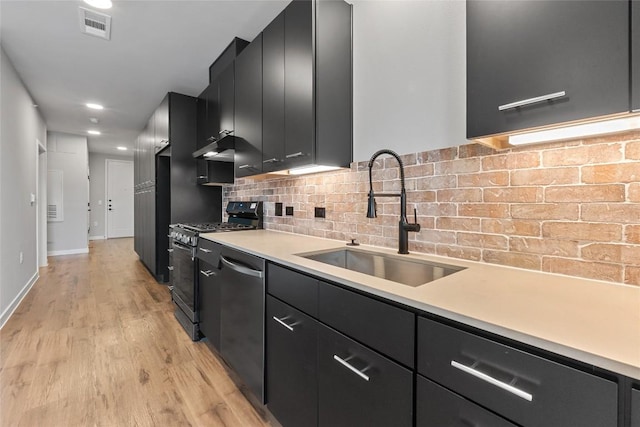 4510 Terry-O Ln Unit 205, Austin, TX 78745 - kitchen featuring dark cabinetry, dishwasher, range with gas stovetop, light wood-style flooring, and light countertops