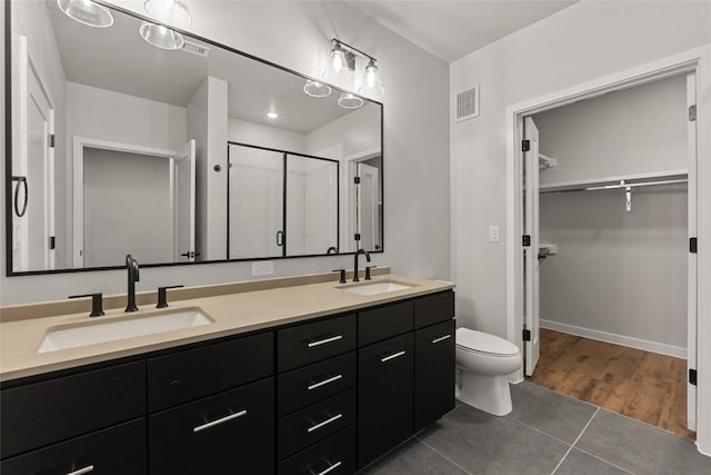4510 Terry-O Ln Unit 205, Austin, TX 78745 - bathroom with double vanity, a shower stall, a spacious closet, and tile patterned flooring