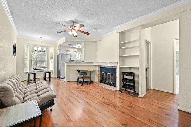 3111 Tom Green St Unit 203, Austin, TX 78705 - living room with crown molding, light wood-style flooring, a textured ceiling, a chandelier, and ceiling fan