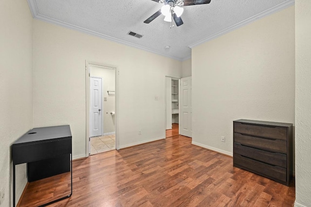 3111 Tom Green St Unit 203, Austin, TX 78705 - unfurnished bedroom with a textured ceiling, wood finished floors, ornamental molding, and ceiling fan