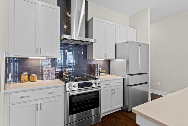 4501 Jackson Ave Unit 5301, Austin, TX 78731 - kitchen with wall chimney range hood, appliances with stainless steel finishes, dark wood-type flooring, backsplash, and white cabinets