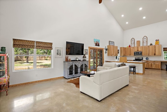 705 Peregrine Way, Leander, TX 78641 - living area featuring high vaulted ceiling, concrete flooring, healthy amount of natural light, and recessed lighting