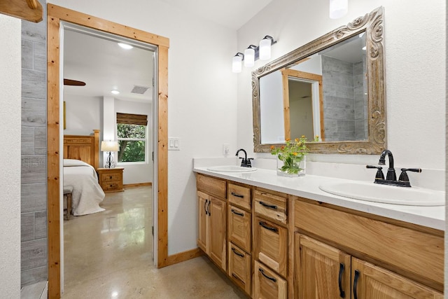705 Peregrine Way, Leander, TX 78641 - bathroom featuring concrete flooring, double vanity, and ensuite bathroom