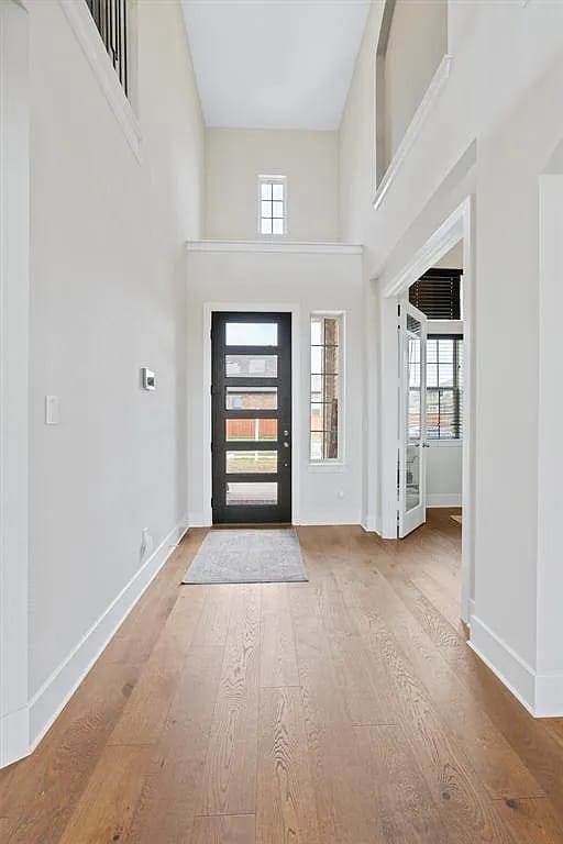 108 Rio Ranchero Rd, Georgetown, TX 78628 - foyer with plenty of natural light, wood finished floors, and a high ceiling
