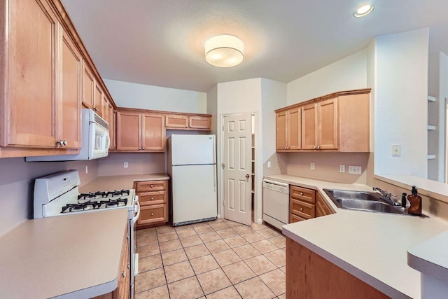 2920 Thrushwood Dr, Austin, TX 78757 - kitchen featuring white appliances, light countertops, light tile patterned floors, recessed lighting, and a peninsula