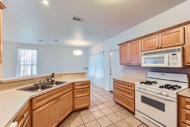 2920 Thrushwood Dr, Austin, TX 78757 - kitchen with white appliances, light countertops, and light tile patterned floors