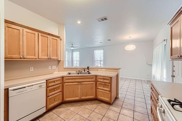 2920 Thrushwood Dr, Austin, TX 78757 - kitchen featuring white dishwasher, light tile patterned floors, a peninsula, light countertops, and range