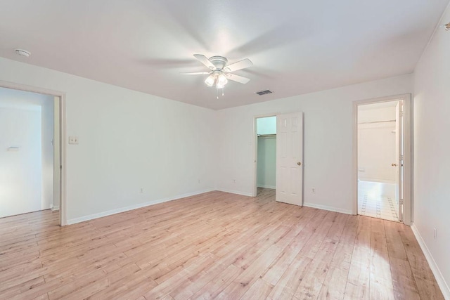 2920 Thrushwood Dr, Austin, TX 78757 - unfurnished bedroom with light wood-style floors, ceiling fan, and a spacious closet