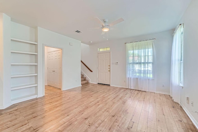 2920 Thrushwood Dr, Austin, TX 78757 - unfurnished living room with stairs, a ceiling fan, light wood finished floors, and built in features