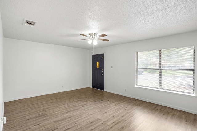 3050 Beacon Fld, San Antonio, TX 78245 - unfurnished room featuring a ceiling fan, wood finished floors, and a textured ceiling