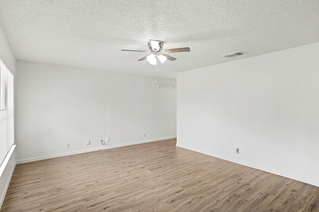 3050 Beacon Fld, San Antonio, TX 78245 - empty room featuring a ceiling fan, light wood-style flooring, and a textured ceiling