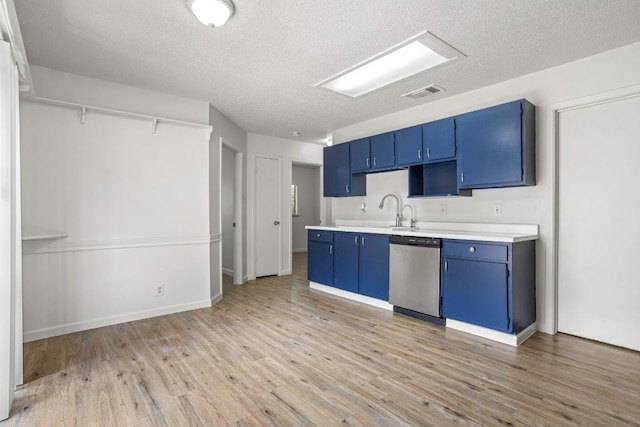 3050 Beacon Fld, San Antonio, TX 78245 - kitchen featuring dishwasher, blue cabinetry, light countertops, a textured ceiling, and light wood-style floors
