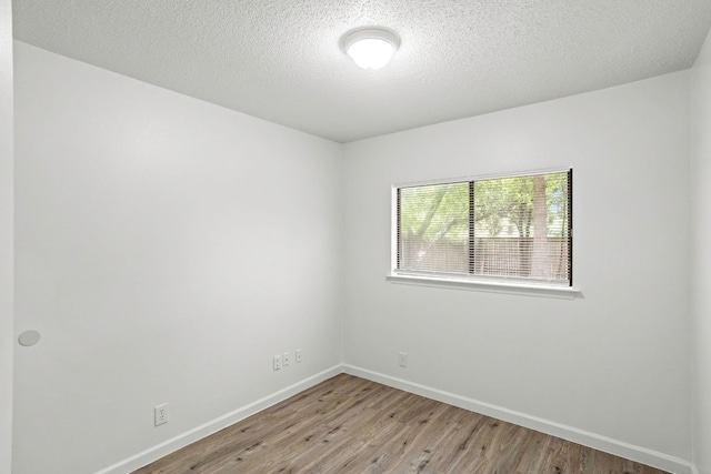 3050 Beacon Fld, San Antonio, TX 78245 - unfurnished room featuring wood finished floors and a textured ceiling