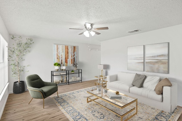 3050 Beacon Fld, San Antonio, TX 78245 - living area featuring plenty of natural light, wood finished floors, ceiling fan, and a textured ceiling