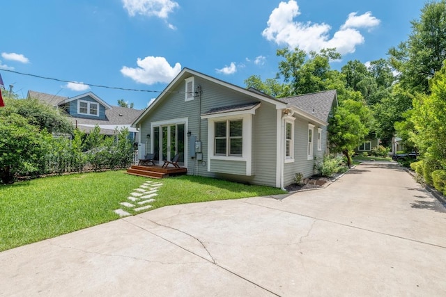 4206 Sinclair Ave, Austin, TX 78756 - back of property featuring a deck, a yard, roof with shingles, and concrete driveway