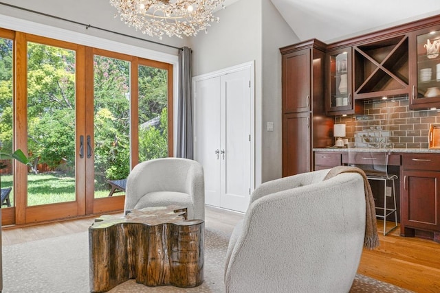 4206 Sinclair Ave, Austin, TX 78756 - living room with a chandelier, light wood-style flooring, and vaulted ceiling