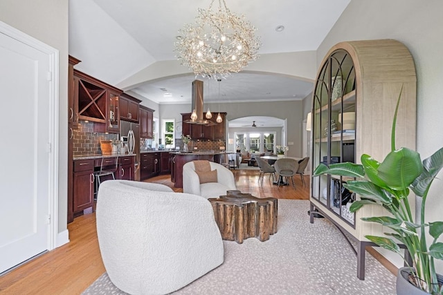 4206 Sinclair Ave, Austin, TX 78756 - living room with arched walkways, a chandelier, and light wood-type flooring