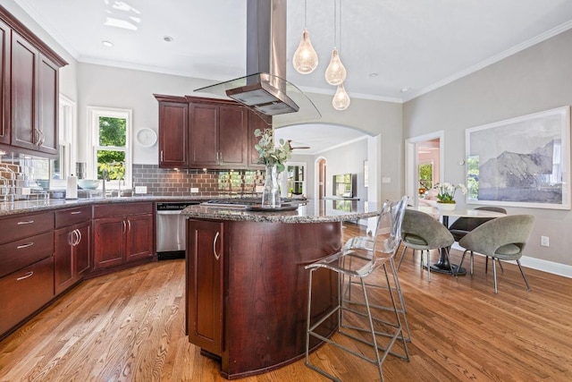 4206 Sinclair Ave, Austin, TX 78756 - kitchen with stainless steel appliances, island range hood, a kitchen island, light wood-style flooring, and dark stone counters