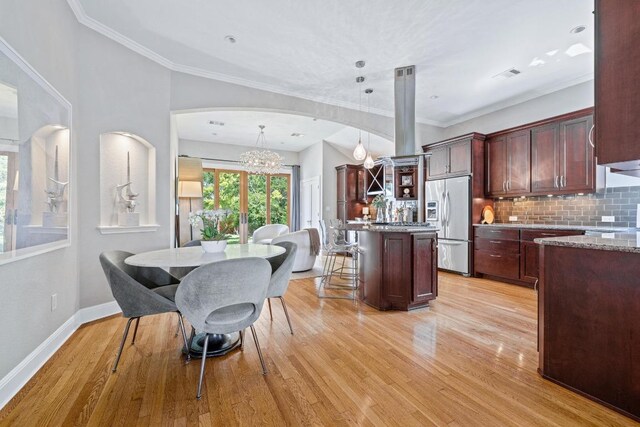 4206 Sinclair Ave, Austin, TX 78756 - kitchen with stainless steel refrigerator with ice dispenser, a chandelier, tasteful backsplash, light wood finished floors, and crown molding