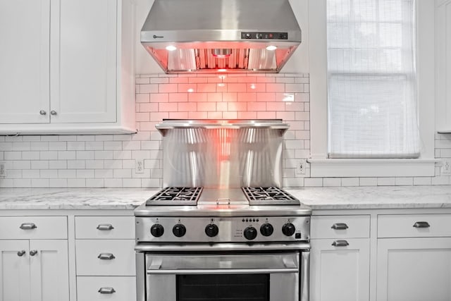607 W 32nd St, Austin, TX 78705 - kitchen featuring exhaust hood, high end range, white cabinetry, decorative backsplash, and light stone countertops