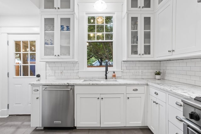 607 W 32nd St, Austin, TX 78705 - kitchen with stainless steel appliances, healthy amount of natural light, white cabinets, and backsplash