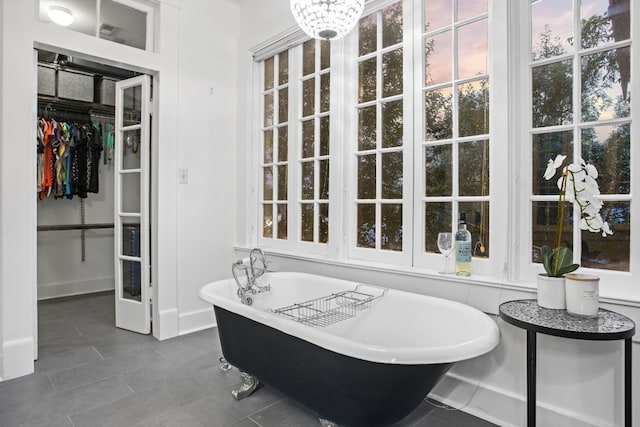607 W 32nd St, Austin, TX 78705 - full bathroom with a freestanding tub, a walk in closet, and tile patterned flooring
