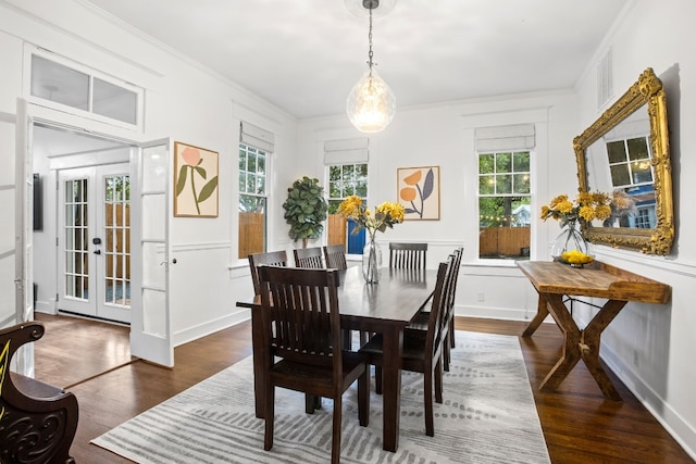 607 W 32nd St, Austin, TX 78705 - dining space with wood finished floors, crown molding, french doors, and a decorative wall