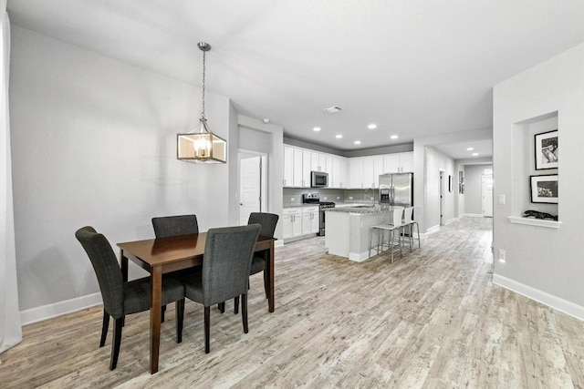 9108 Alex Ln, Austin, TX 78748 - dining area with light wood-style flooring and recessed lighting