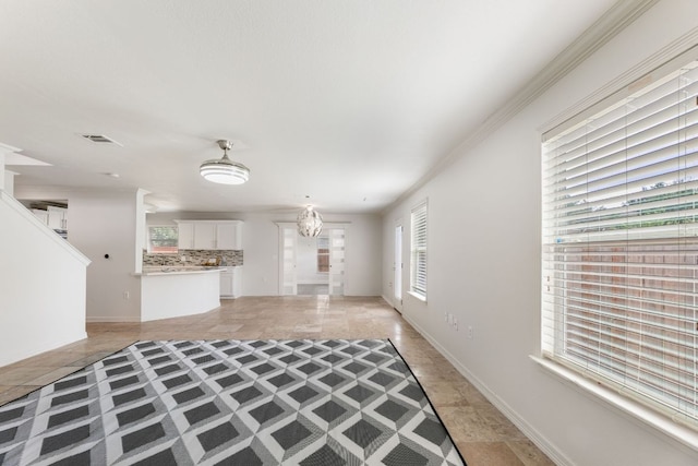 6828 Walkup Ln, Austin, TX 78747 - unfurnished living room with a chandelier and ornamental molding