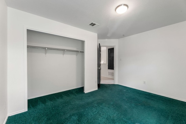 6828 Walkup Ln, Austin, TX 78747 - unfurnished bedroom with dark colored carpet and a closet
