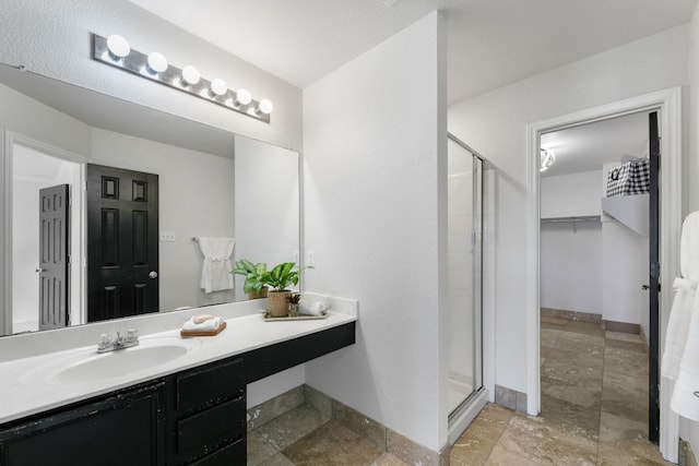 6828 Walkup Ln, Austin, TX 78747 - full bathroom featuring a shower stall, stone finish flooring, and vanity